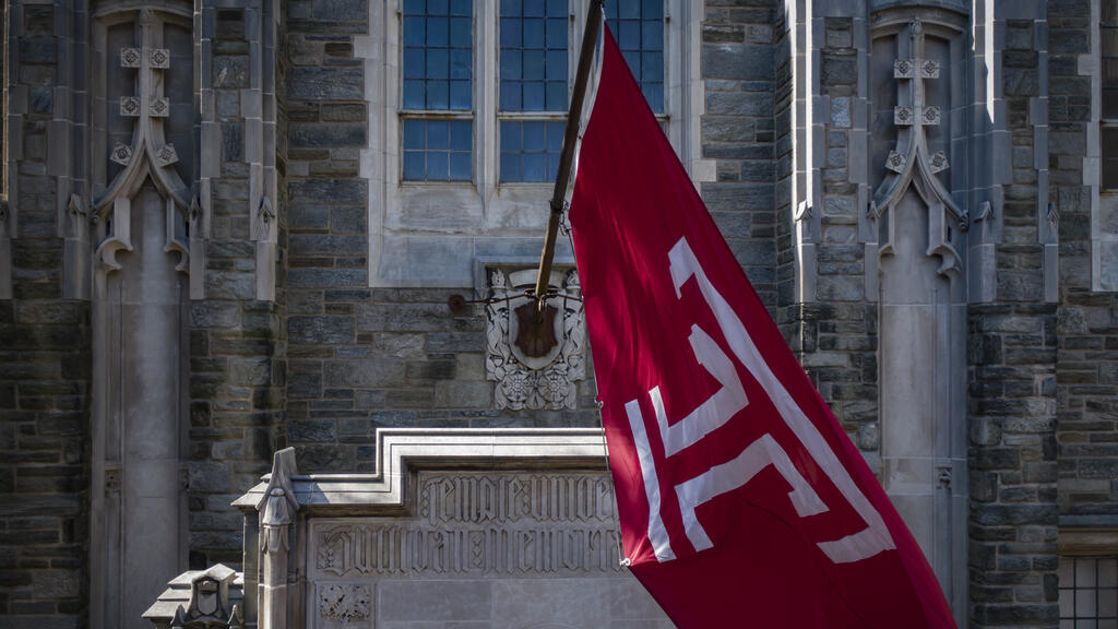 The Temple T flag waving on campus