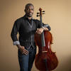 Ajibola standing next to his cello