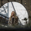 Lindsey Casella poses for a photo under string lights.