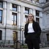 Anna Breece standing in front of Philadelphia's City Hall.