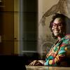 Elizabeth Blake poses for a photo in a library.
