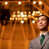 Trevor Tran standing in a concert hall.