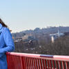 Stephanie Javier Fagbemi leaning against a red railing.