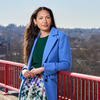Stephanie Javier Fagbemi leaning against a red railing.