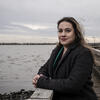 Honoree Brittney Martinez standing on a dock over the Delaware River and smiling 