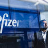 abstract photo of Nick Rivera in front of Pfizer sign.