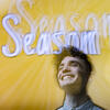 Nick Santangelo smiling in front of the Season 1 title screen.