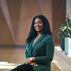 30 Under 30 honoree Brittany Lue wearing a green suit and sitting with her hands folded in her lap
