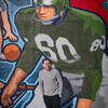 Raul Vegas smiling in front of a Philadelphia sports mural.
