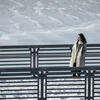 30 Under 30 honoree Andrea Behler walking on a snow covered bridge