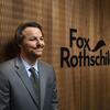 Sam Finkel sits and poses at Fox Rothschild.