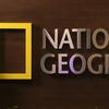 Amanda Petty poses in front of the National Geographic logo.
